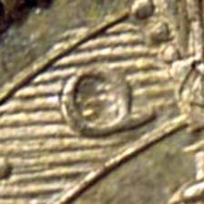 A close-up of a coin

Description automatically generated